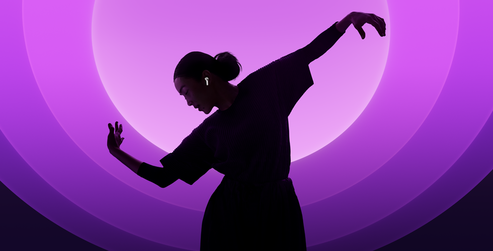 A person dancing while wearing AirPods 5, multi-color background