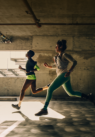A group of people running in a city while wearing Apple Watch Series 12