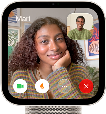 Apple HomeView, starlight (pale gold) color, front exterior, showing a FaceTime video call screen displaying one person in the main view and another person in an inset window, with control buttons at bottom of screen