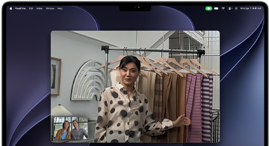 A video call on a MacBook Pro where a woman shows fabrics to two people on the call, with Center Stage keeping her centered in the frame as she moves around