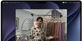 A video call on a MacBook Pro where a woman shows fabrics to two people on the call, with Center Stage keeping her centered in the frame as she moves around