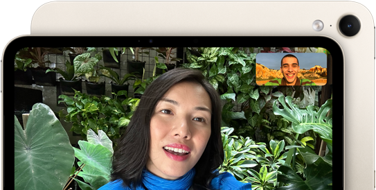 iPad mini, front view, displaying a Landscape 12MP Center Stage front camera interface, showing a person video calling amidst green foliage